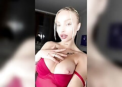 Blond honey teases her titties in red whilst staring right at u ?