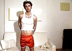 Stud teases with his bare feet and strokes his dick