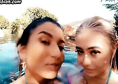 Enormous breasted dykes scissoring on swimming pool outdoor