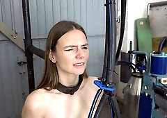 Slim brunette with small, saggy tits is sitting on a Sybian while her hands are tied up