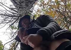 Bulky bodybuilder is milking off in woods outdoor public place