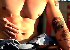 Tattooed stud having masturbation in the gym