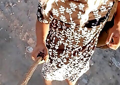 Elegant trans beauty strolls in public with a dress and high heels sporting a sexy anal plug