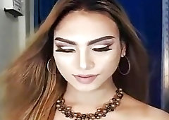 Glamorous amateur shemale performs a seductive striptease before jerking off