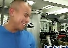 Muscular stud tugging cock in the gym