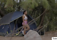 Breasty t-girl and her ally are in the woods setting up their tent.After that,her lascivious ally masturbates her vagina and mouths some dick on the a
