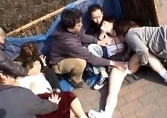 Two cute Asian babes getting used by a group of boys outside