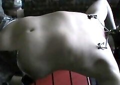 Restrained slave on a cage