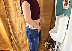Nerdy faery shows off her standing pee in a public toilet