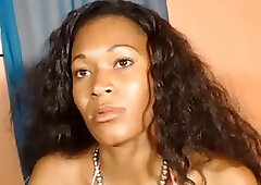 Black woman in pink bra is rubbing her hairy pussy in front of the web camera