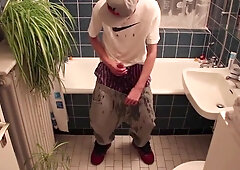Young man urinating himself
