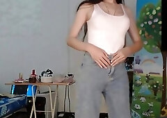 Adorable brunette shemale playfully teases and strips her cute outfit