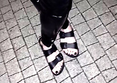 Seductive crossdresser showcases fetish for latex and high heels outdoors