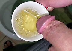 Guy Urinating in a Mug (close-up)