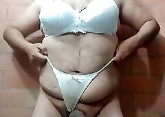 Sensual Latina transvestite undresses and masturbates with her white thong and her cock