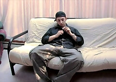 A stud in a baseball cap peels off and masturbates off on the bed