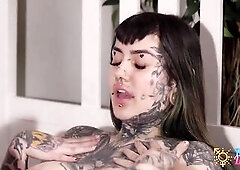 In a dimly lit room, a heavily tattooed transgender transsexual dominates the scene, her inked body glistening with sweat. That babe mounts a tattooed
