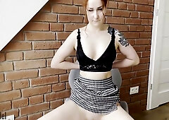 Redheaded Kleo model fingers herself under her checkered skirt to orgasm
