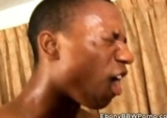 Big, black lady is wearing red leather boots with high heels and nothing else while having sex