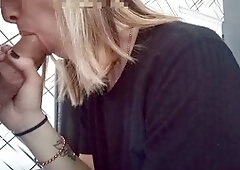 Blonde girl gives blowjob and footjob in close-up action