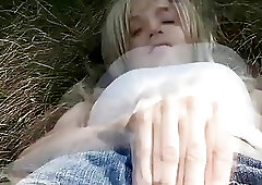 Horny shemale exhibitionist enjoys masturbation on bales of hay outside