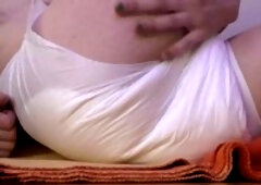 Adorable young twink experiences his first time in a diaper, wetting himself cutely!