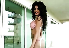 Voluptuous tranny shows her curves and strokes her big cock