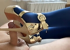 Hot MILF gives a shoejob with shiny gold platforms and blue nylons, ending with a massive cumshot