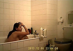 Brunette cutie enjoys a hot shower in the bathroom