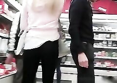 Blond and brunette hair women walking on the street in constricted jeans and taut panties. They go to supermarket and voyeur follows and films their b