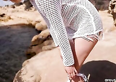 Arousins.com movie scene! Gorgeous Lana Lane teases us on some rocks with the sea behind her. Have a fun the full 4k movie at Arousins.com