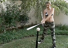 Trainer shows two female athletes how to properly handle a large bat