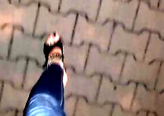 a crossdresser with astonishing feet walks on the street in high heel wedges and taut jeans and tempts boys