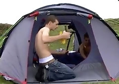 two English youngsters milking and blowing in camp tent 1