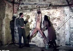 Hanging at the wall with her legs widen wide apart the female prisoner is made sexy by lashes (preview)