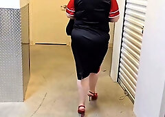 Mature American woman explores her big ass with a toy in a dim warehouse