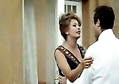 Sophia Loren pulling her robe open and dropping it to the floor, showing good cleavage in some hawt underware as this babe faces a chap and this guy w