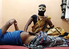 Masked ebony Indian woman teases a sensual ride on her webcam from a red bed