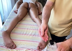 Viva Athena gives an oiled footjob during a sensual massage session