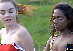Ebony and creamy skinned lesbians engage in outdoor girl-on-girl fun