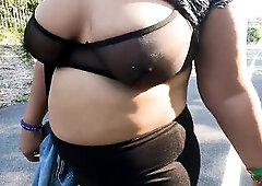 Wife talking a walk throughout park in mesh shirt and brassiere