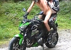 Two Muscular Guys On A Green Motorcycle