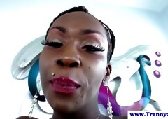 Ebony shemale rubs oil on her dick before jerking