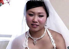 The fresh Oriental bride remains attired in her bridal gown through a visitor's arrival