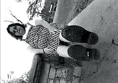 Nurse vicki models in her ebony and whot hogwarts outfit and spiked boots