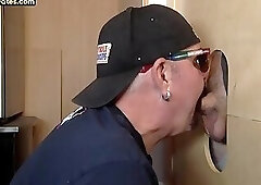 Gray DILF wanking dick while giving gloryhole blowjob