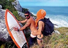 A cheeky surfer getting a prick and urinate from a tourist.