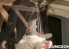 Gagged brunette is spanked by master in dungeon play