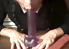 Sissy clothed as Wednesday Addams mouth training with 2 different dildos; a double ended sextoy, and a purple "Size Queen" vibrator