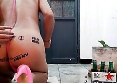 Sissy in micro bikini and pink heels taking an anal beer